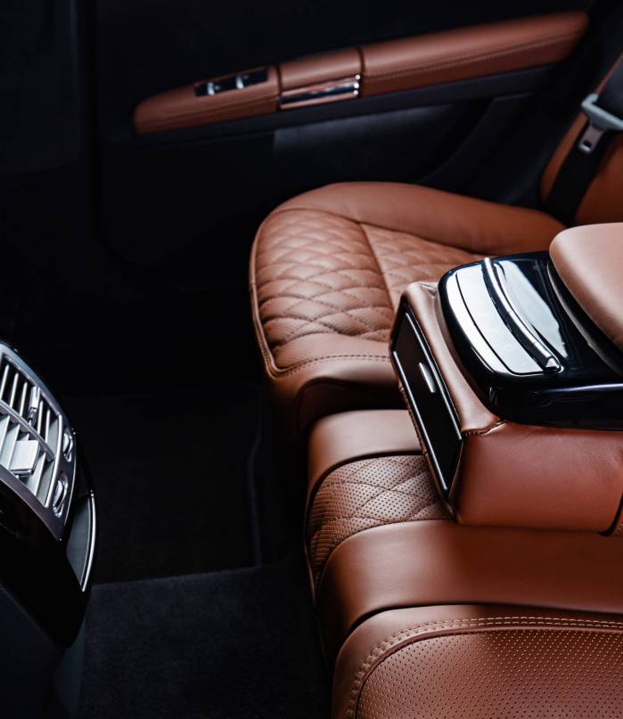 A luxury car interior in brown and black colors